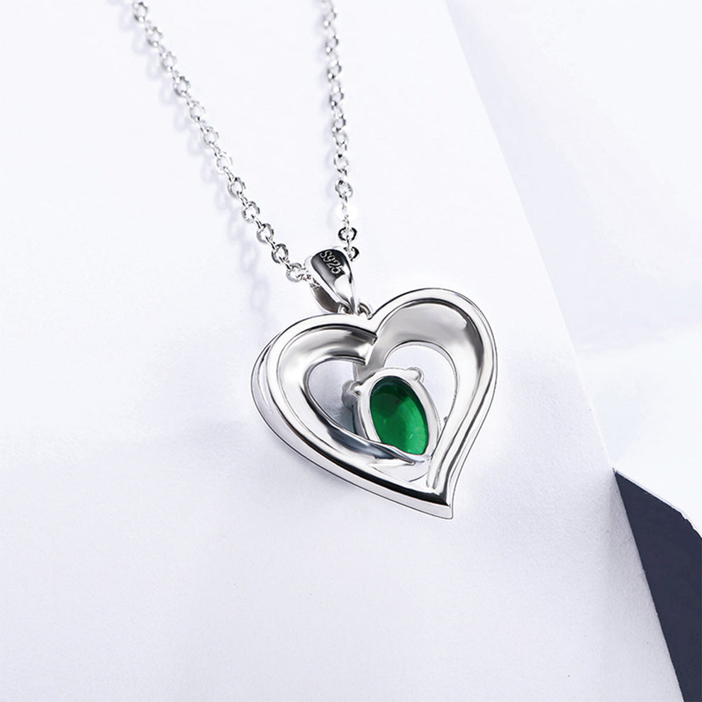 Women's Sterling Silver Channel Setting Hollow Heart Shape Pendant with Oval Brilliant Cut Emerald Gem